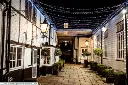 The-courtyard-at-night-The-Talbot-Inn-bespoke-hotels-Ripley-near-Wisley-Places-to-stay-in-Surrey-Visit-England-V5.webp